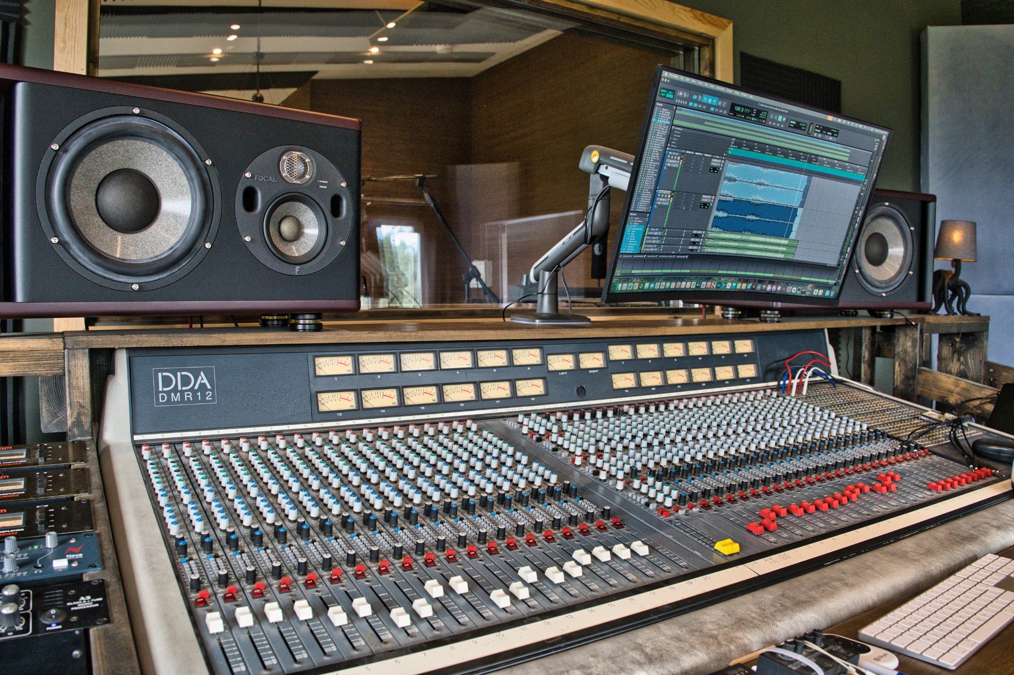 Pound House Productions control room with mixing console and studio window